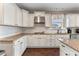 Kitchen with white cabinets, granite countertops, stainless steel appliances, and a view to the backyard at 404 Topcrest Ln, Moncks Corner, SC 29461