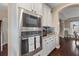 Kitchen area features built-in stainless steel microwave and oven with white cabinets at 404 Topcrest Ln, Moncks Corner, SC 29461