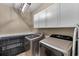 Convenient laundry room featuring a washer, dryer, and ample storage cabinetry at 404 Topcrest Ln, Moncks Corner, SC 29461