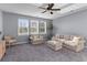 Inviting living room with large windows, neutral tones, and comfortable seating arrangement at 404 Topcrest Ln, Moncks Corner, SC 29461