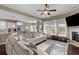 Bright living room featuring a large sectional sofa, fireplace, and an open layout to the kitchen at 404 Topcrest Ln, Moncks Corner, SC 29461