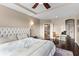 Main bedroom showing tufted headboard, ceiling fan and access to ensuite bathroom and spacious closet at 404 Topcrest Ln, Moncks Corner, SC 29461