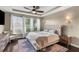 Comfortable main bedroom featuring a plush bed, a ceiling fan, and natural light from large windows at 404 Topcrest Ln, Moncks Corner, SC 29461