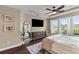 Main bedroom with a large window, a ceiling fan, dresser, and a mirror for added natural light and space at 404 Topcrest Ln, Moncks Corner, SC 29461