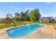 Sparkling pool with lush landscaping, surrounded by a secure fence, creating a private backyard oasis at 404 Topcrest Ln, Moncks Corner, SC 29461