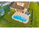 Aerial view of a backyard with a pool, lounge chairs, fire pit, and lush green lawn at 404 Topcrest Ln, Moncks Corner, SC 29461