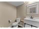 Bright powder room features white vanity with black hardware and a square framed mirror at 404 Topcrest Ln, Moncks Corner, SC 29461