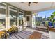 Inviting screened porch with neutral colors, outdoor furniture, and playful ' corner, extending the living space at 404 Topcrest Ln, Moncks Corner, SC 29461