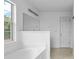 Bright bathroom with a large mirror, overhead lighting, and white cabinets at 412 Beverly Dr, Summerville, SC 29485