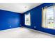 Bright bedroom featuring blue walls, carpet, and natural light from two windows with neutral curtains at 412 Beverly Dr, Summerville, SC 29485