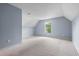 Light and airy bedroom with sloped ceilings, neutral walls and carpet, and a bright window at 412 Beverly Dr, Summerville, SC 29485
