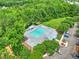 Aerial view of a community pool with lounge chairs, clubhouse, and ample parking surrounded by trees at 412 Beverly Dr, Summerville, SC 29485