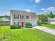 Charming two-story home with a well-manicured lawn, red front door, and attached garage at 412 Beverly Dr, Summerville, SC 29485