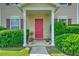 Charming front porch with a red door, columns, and manicured landscaping at 412 Beverly Dr, Summerville, SC 29485