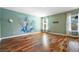 Spacious living room with hardwood flooring, an artistic accent wall, and lots of natural light at 412 Beverly Dr, Summerville, SC 29485