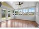 Bright sunroom featuring wood floors, a ceiling fan, and backyard views at 412 Beverly Dr, Summerville, SC 29485