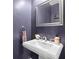 Stylish powder room featuring a pedestal sink, decorative mirror, and elegant fixtures at 4419 Louisa Lane Ln, North Charleston, SC 29405