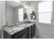 Bathroom featuring a granite countertop, dark wood cabinets, and a bright, airy atmosphere at 4419 Louisa Lane Ln, North Charleston, SC 29405