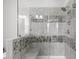 Modern bathroom with glass shower, stone accents, built-in bench, and tiled walls at 4419 Louisa Lane Ln, North Charleston, SC 29405
