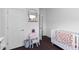 A bright Bedroom with a crib, round mirror, wooden shelf and gray waste basket at 4419 Louisa Lane Ln, North Charleston, SC 29405