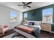 A stylish bedroom features a striking accent wall, plush bedding, and ample natural light at 4419 Louisa Lane Ln, North Charleston, SC 29405