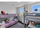 Bright bedroom featuring gray metal bunk beds, plush bedding, and natural light from two windows at 4419 Louisa Lane Ln, North Charleston, SC 29405