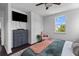 Cozy bedroom features a ceiling fan, a soft accent chair, natural light, and ample storage at 4419 Louisa Lane Ln, North Charleston, SC 29405