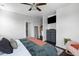 Bright bedroom with ceiling fan, soft chair, adjacent bath, walk-in closet, and dark wood floors at 4419 Louisa Lane Ln, North Charleston, SC 29405