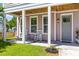 Inviting front porch with rocking chairs and charming pastel exterior at 4419 Louisa Lane Ln, North Charleston, SC 29405