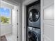Modern laundry closet with stacked washer and dryer, conveniently located near a sunlit window at 4419 Louisa Lane Ln, North Charleston, SC 29405