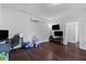 Large playroom with a mounted flat screen TV, desk and various toys for playing at 4419 Louisa Lane Ln, North Charleston, SC 29405