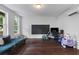 Spacious playroom with dark hardwood floors, chalkboard wall, and mini-split system at 4419 Louisa Lane Ln, North Charleston, SC 29405