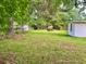 View of the large backyard featuring green grass and some trees at 4470 Farmwood Ct, Ladson, SC 29456