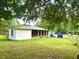 Large backyard featuring a white painted brick building with a covered patio perfect for outdoor gatherings at 4470 Farmwood Ct, Ladson, SC 29456