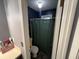 Small full bathroom with blue accent wall and shower with green curtain at 4470 Farmwood Ct, Ladson, SC 29456