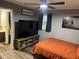 Bedroom with modern furniture including a large TV and natural light from the window at 4470 Farmwood Ct, Ladson, SC 29456