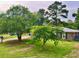 Landscaped front yard showcases the classic brick home with dark shutters, creating a welcoming curb appeal at 4470 Farmwood Ct, Ladson, SC 29456