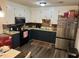 Well-lit kitchen with stainless steel refrigerator, dark blue bottom cabinets and vintage coca-cola soda machine at 4470 Farmwood Ct, Ladson, SC 29456