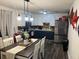 Kitchen and dining room with a stainless-steel fridge and blue cabinets, showcasing a modern design at 4470 Farmwood Ct, Ladson, SC 29456