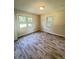 Bedroom with wood-look floors and bright natural light through two windows at 449 Estates Dr, Walterboro, SC 29488