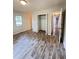 Spacious bedroom with wood floors, closet, and natural light from the window at 449 Estates Dr, Walterboro, SC 29488