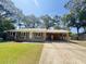 Inviting brick home featuring a covered carport and well-kept lawn at 449 Estates Dr, Walterboro, SC 29488
