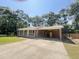 Inviting brick home featuring a covered carport and well-kept lawn at 449 Estates Dr, Walterboro, SC 29488
