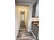 Hallway leading to bedrooms featuring wood-look floors at 449 Estates Dr, Walterboro, SC 29488