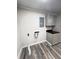 Functional laundry room with countertop and cabinets and wood-look flooring at 449 Estates Dr, Walterboro, SC 29488