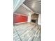 Open concept living room with brick fireplace and wood-look floors and red accent walls at 449 Estates Dr, Walterboro, SC 29488