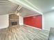Open concept living room with brick fireplace and wood-look floors and red accent walls at 449 Estates Dr, Walterboro, SC 29488