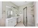 Updated bathroom features a glass-enclosed shower, large mirror, and vanity with ample storage at 4626 O'Hear Ave, North Charleston, SC 29405