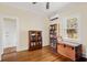 Cozy bedroom featuring hardwood floors, a ceiling fan, and multiple shelves stocked with books at 4626 O'Hear Ave, North Charleston, SC 29405