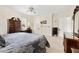 Traditional bedroom features neutral paint, carpet, ceiling fan, and stylish dark wood furniture at 4626 O'Hear Ave, North Charleston, SC 29405